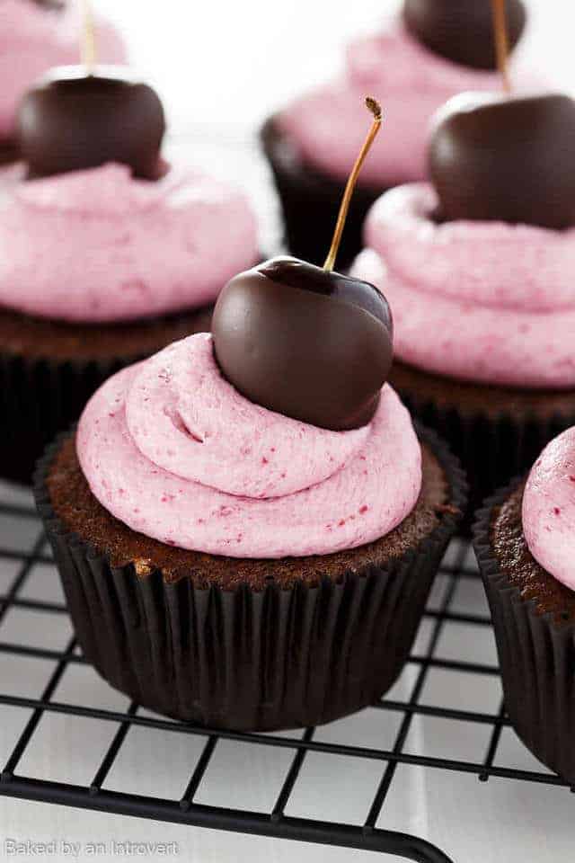 Chocolate cherry cupcakes on a wire rack.