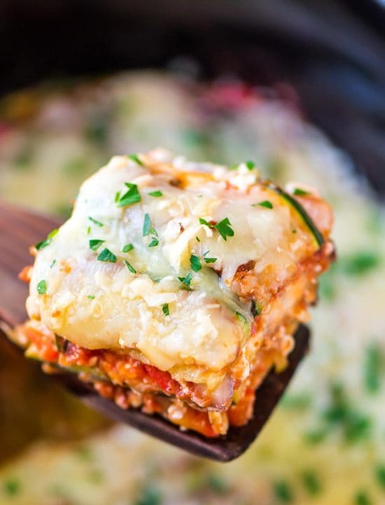 spatula holding a low carb slice of crock pot lasagna made with zucchini