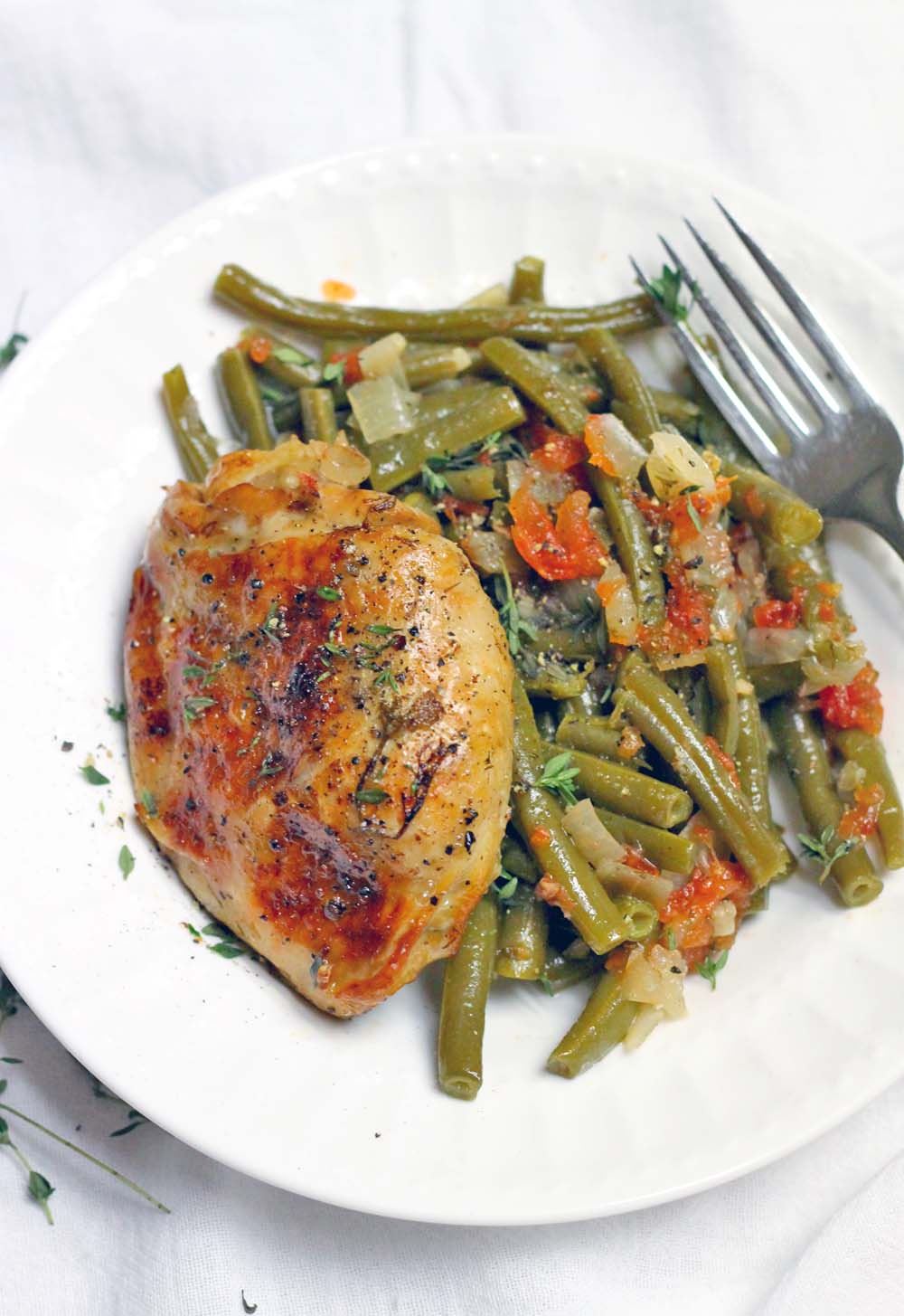 Slow Cooker Greek-Style Green Beans and Chicken thighs is the ULTIMATE one-pot meal: everything cooks in your crockpot at once! Plus, it
