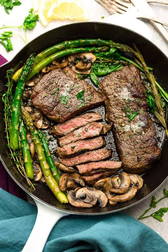 Pan Seared Steak with Garlic, Herb Butter, Asparagus and Mushrooms