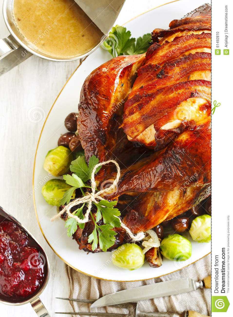 Prepared Turkey For Thanksgiving
 Roasted Turkey With Bacon And Garnished With Chestnuts And