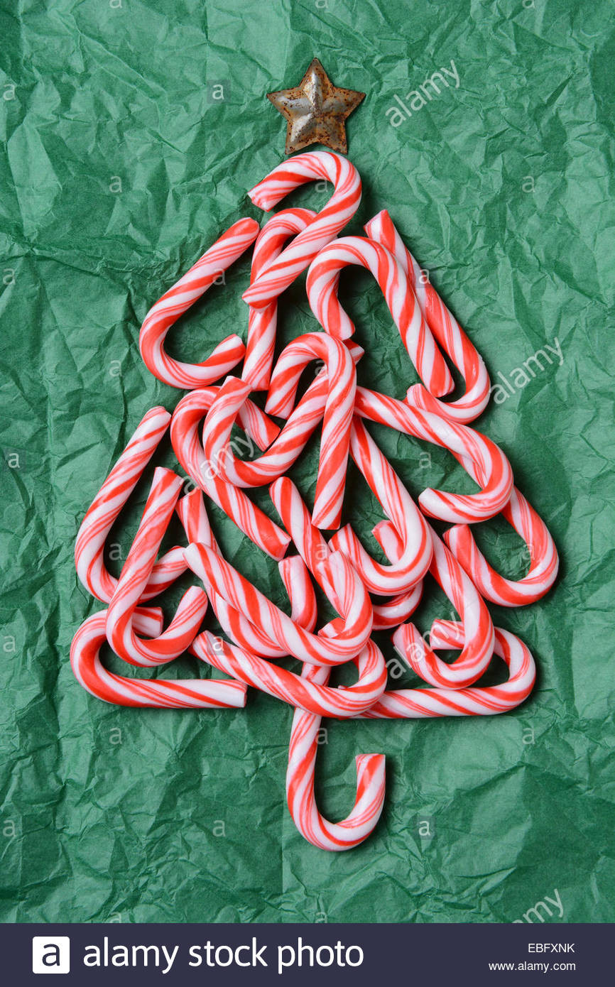 Why Are Candy Canes Associated With Christmas
 Christmas tree shape made out of candy canes on a green